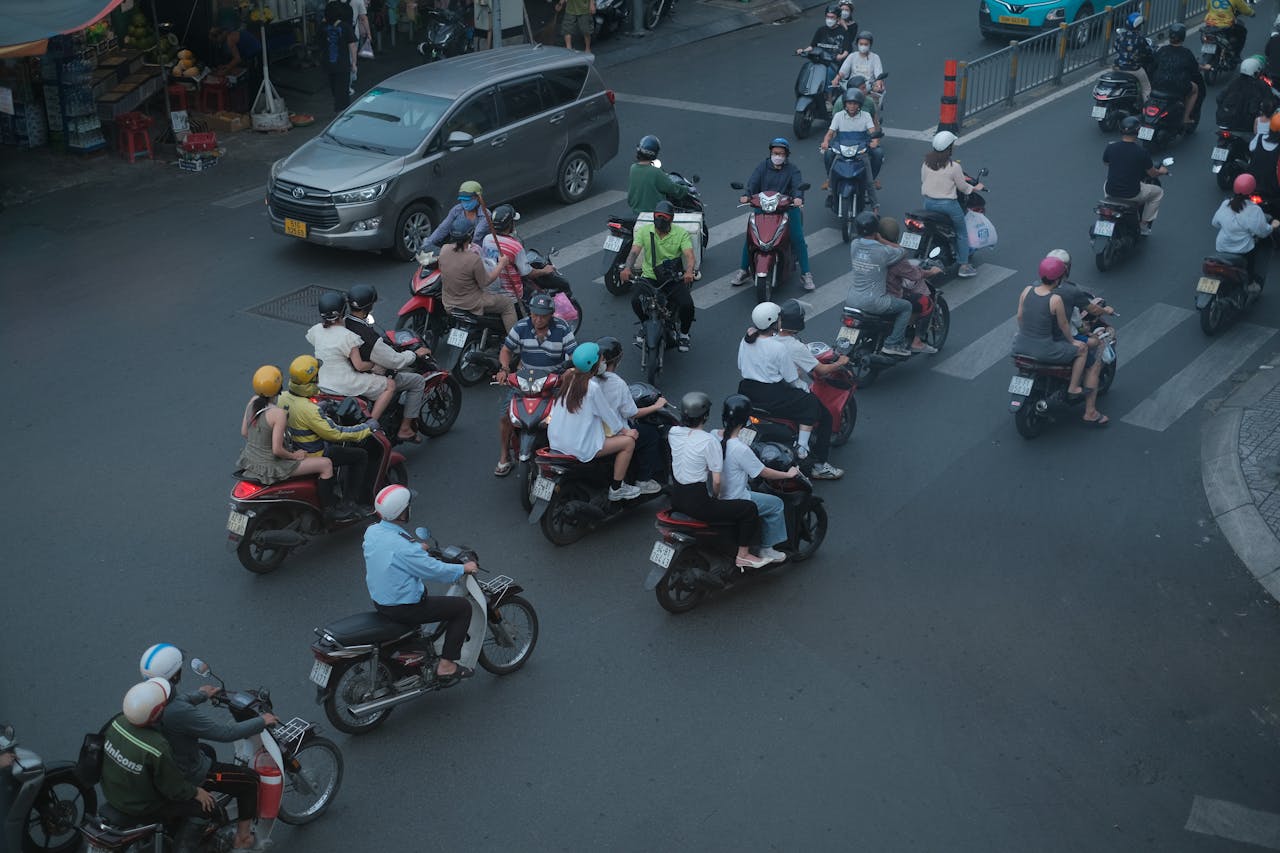 Vibrant street scene showcasing traffic flow with multiple motorbikes and pedestrians.
